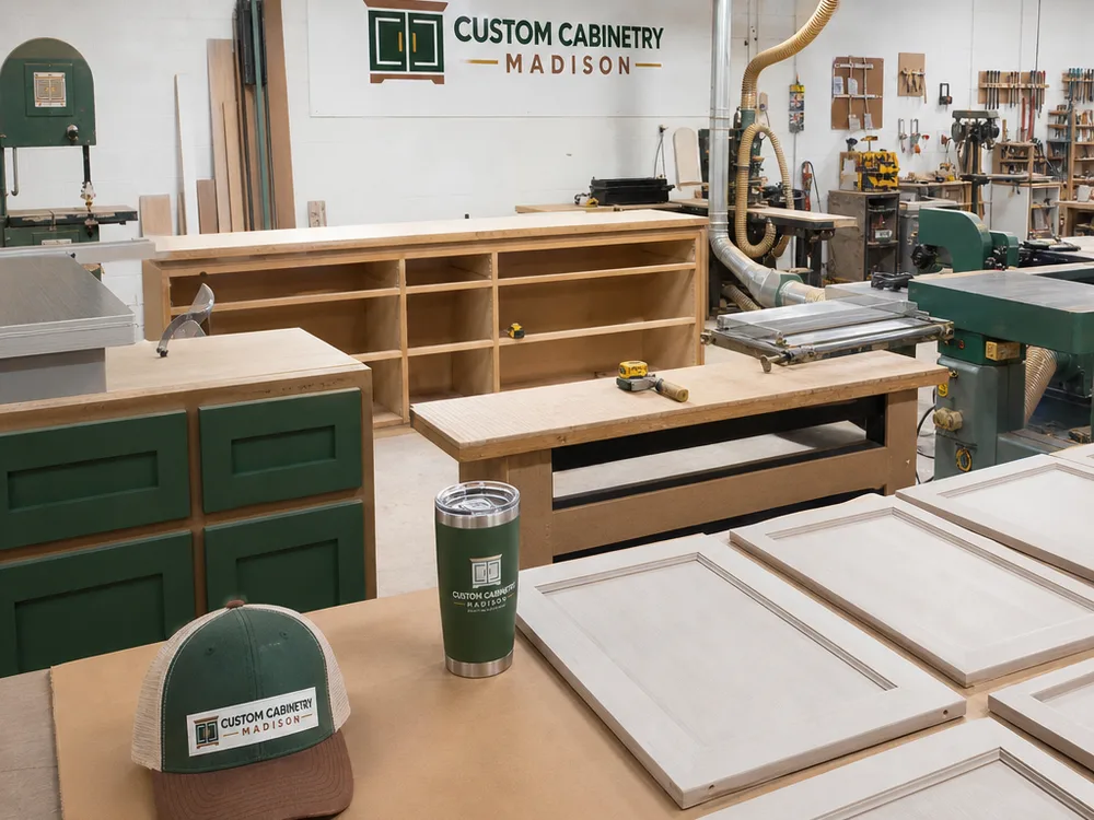 Cabinet shop with assembled boxes, doors prepared for finishing, and precision joinery tools